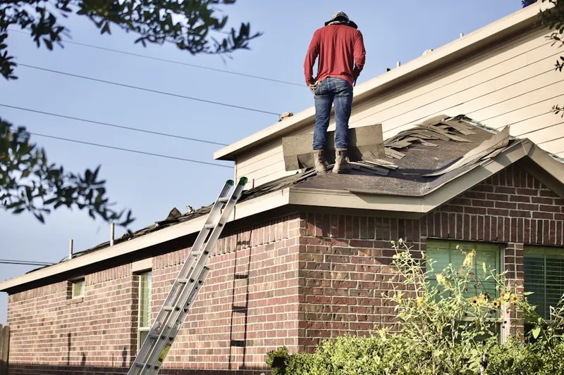 Professional roofer working on a residential roof in Foxwood Village